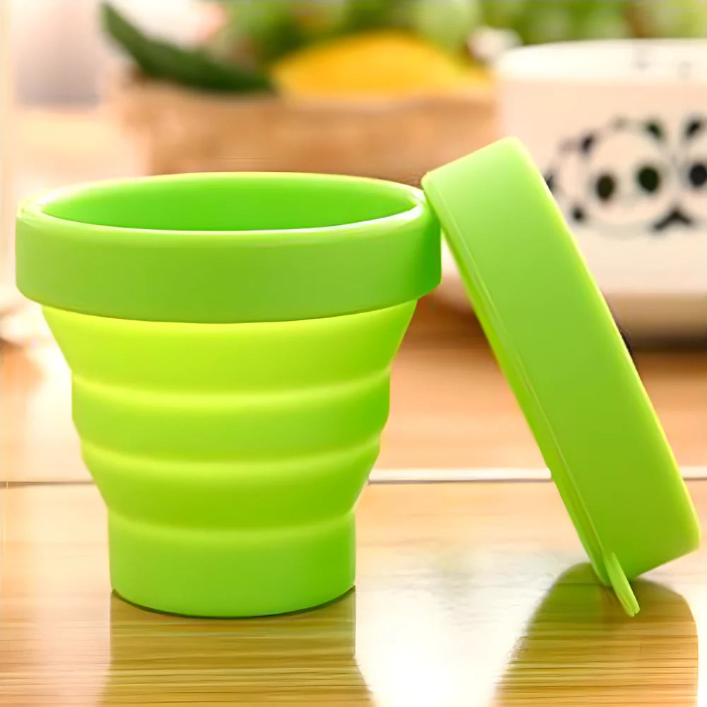 Green silicone foldable travel mug with lid and carry handle