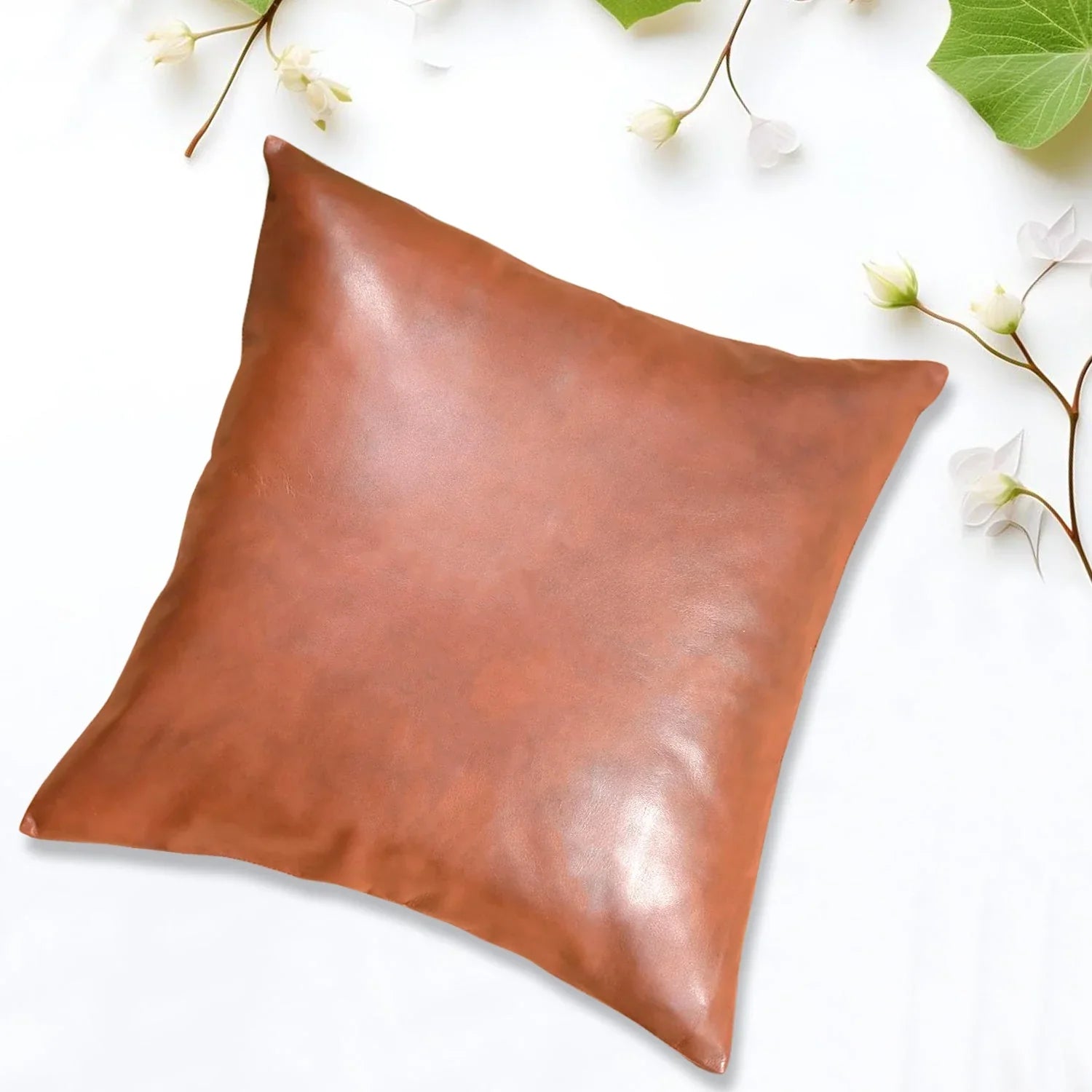 Square decorative pillow cover, smooth brown fabric with subtle sheen and folded corner seam
