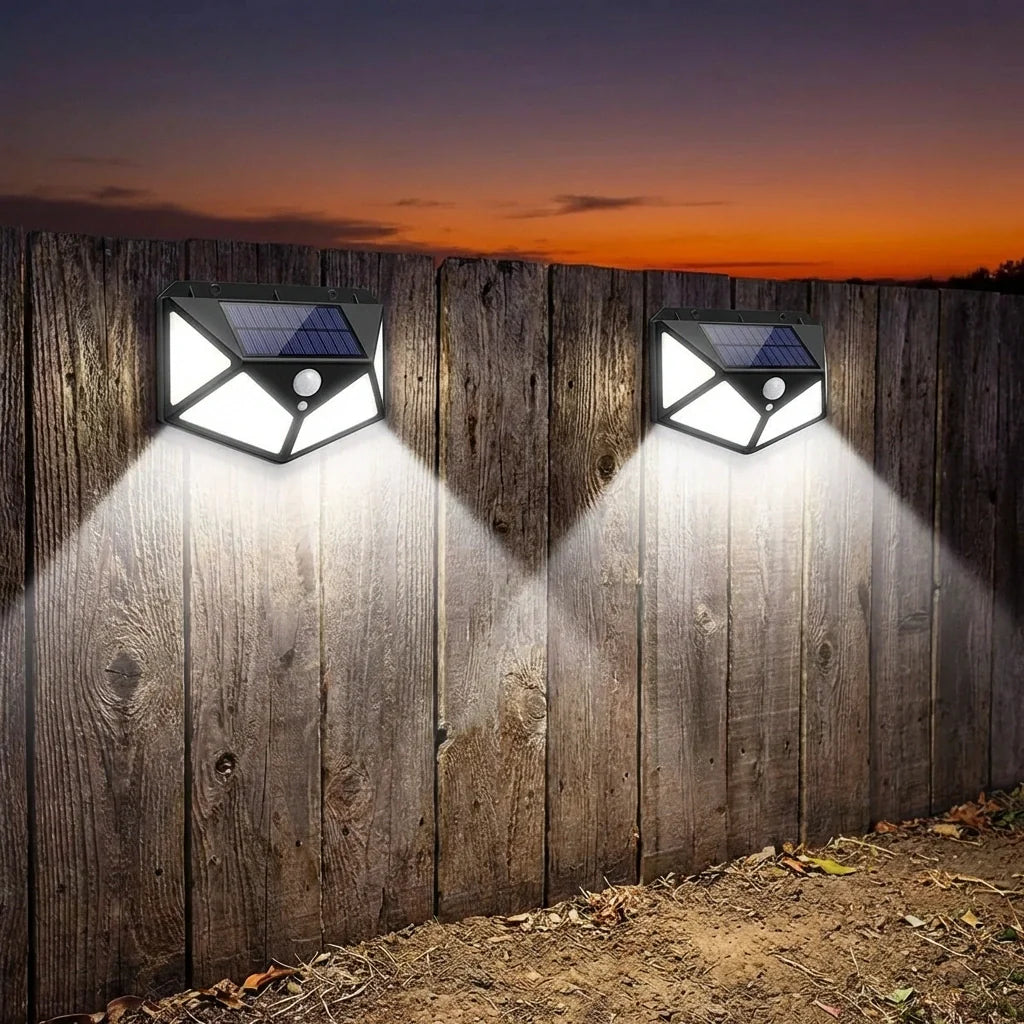 Solar wall lights mounted on wood fence, two units shining bright