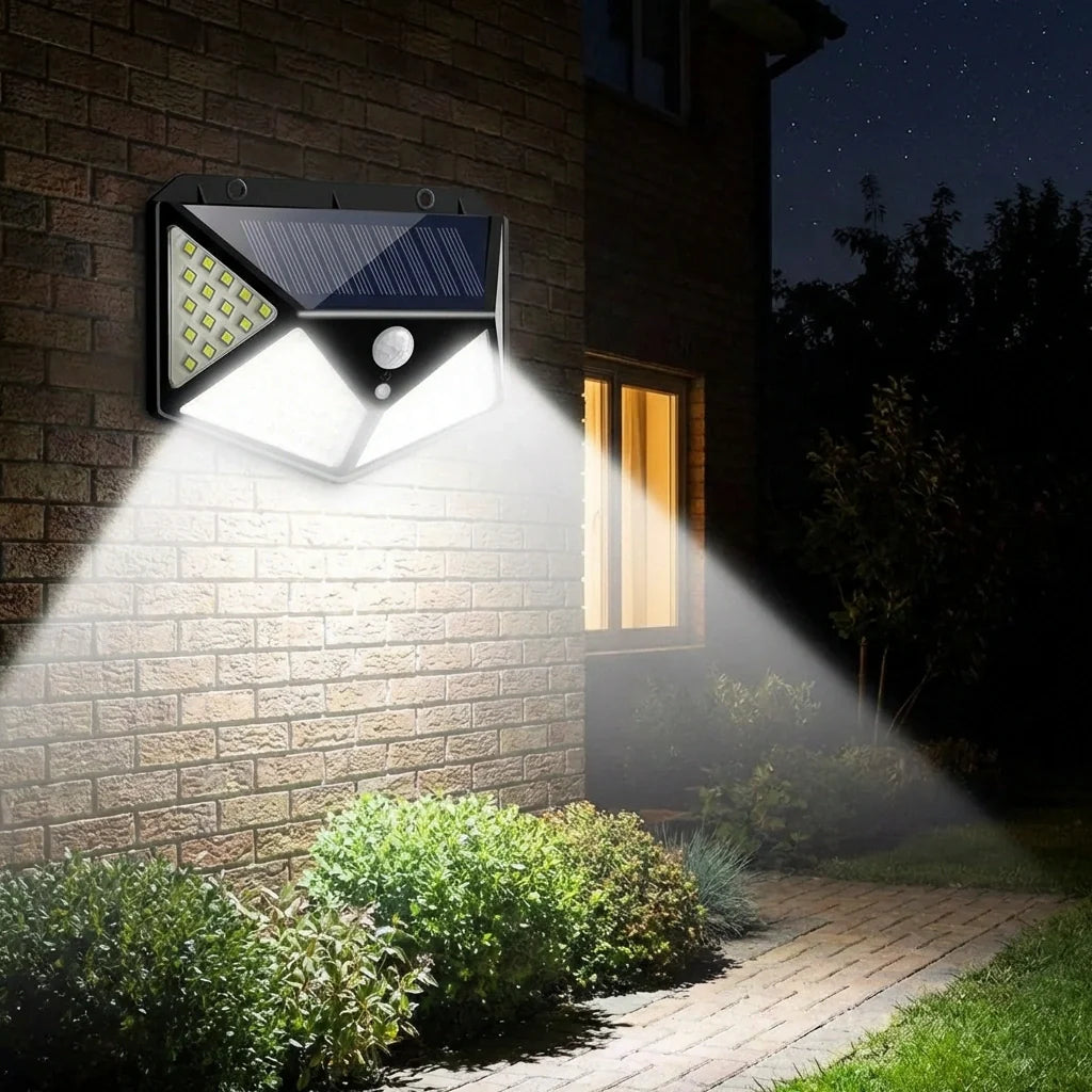 Solar wall light casting wide beam beside brick wall and doorway