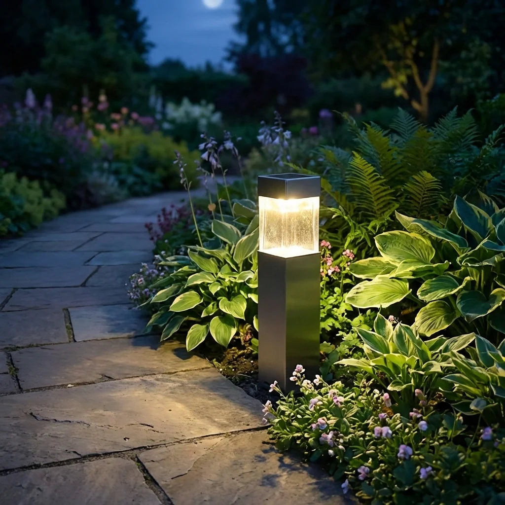 Solar pathway garden light, dark rectangular post with warm glow on ground