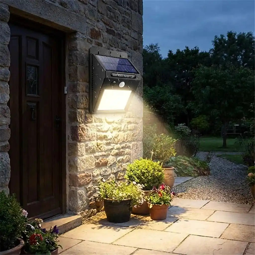 Solar motion LED wall light mounted beside a door, casting a wide beam