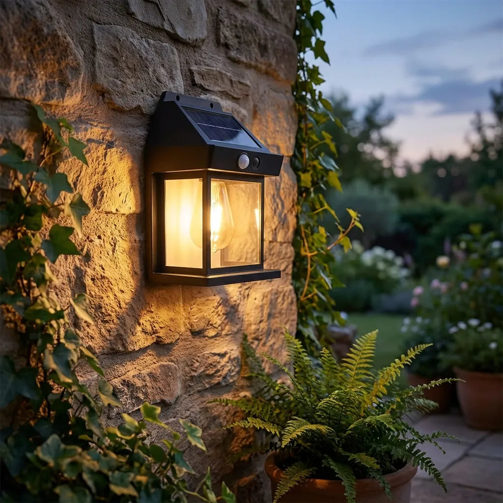 Solar wall lantern light with black metal housing, solar panel top, warm glowing bulb
