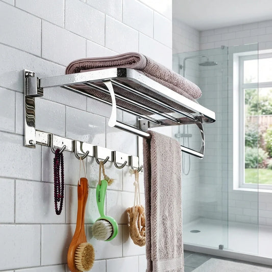Wall-mounted folding towel rack with chrome bar, hooks, and folded hand towels