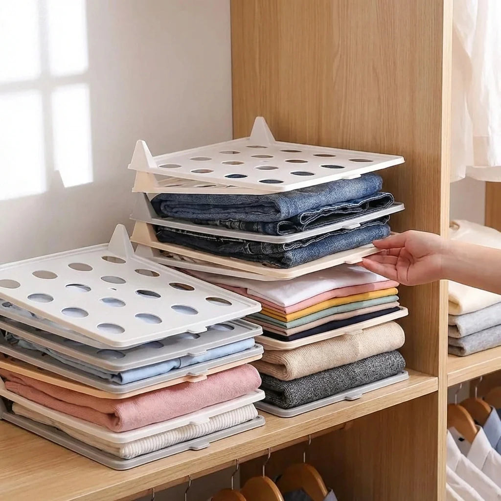 Clothes folding boards, white plastic with round hole pattern, stacked with clothes