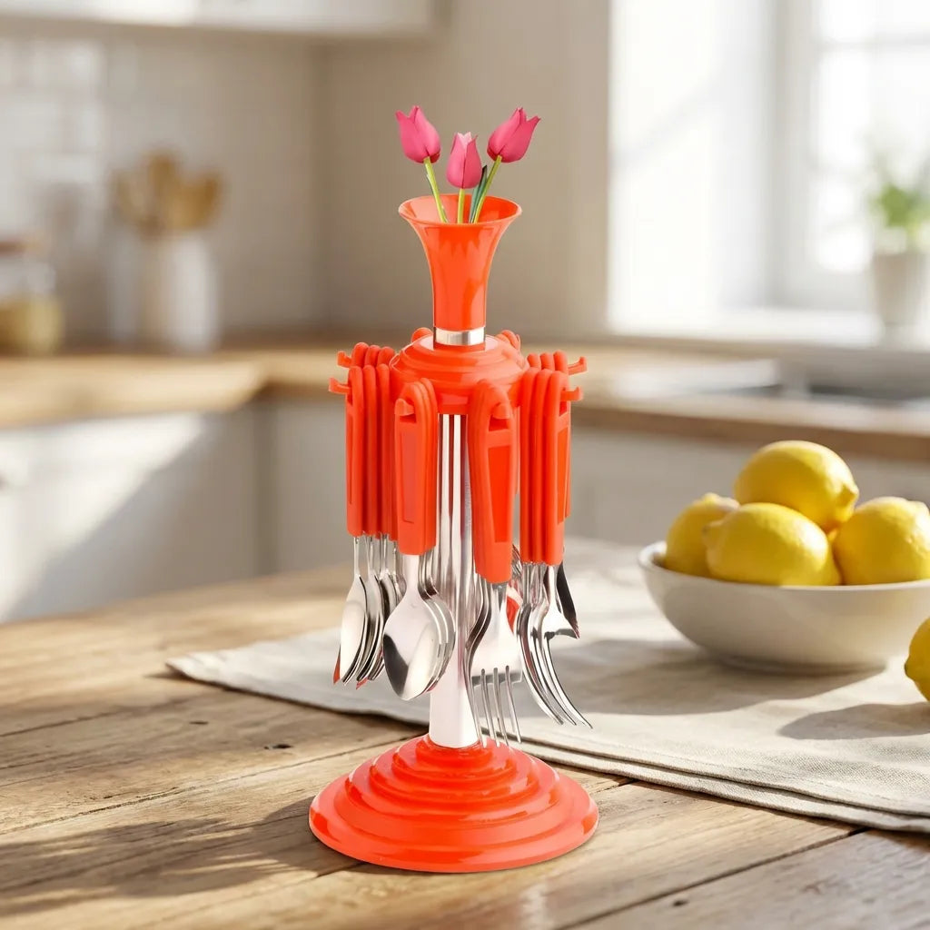 Stainless cutlery set with an orange base and metal forks and spoons, centered on the table.