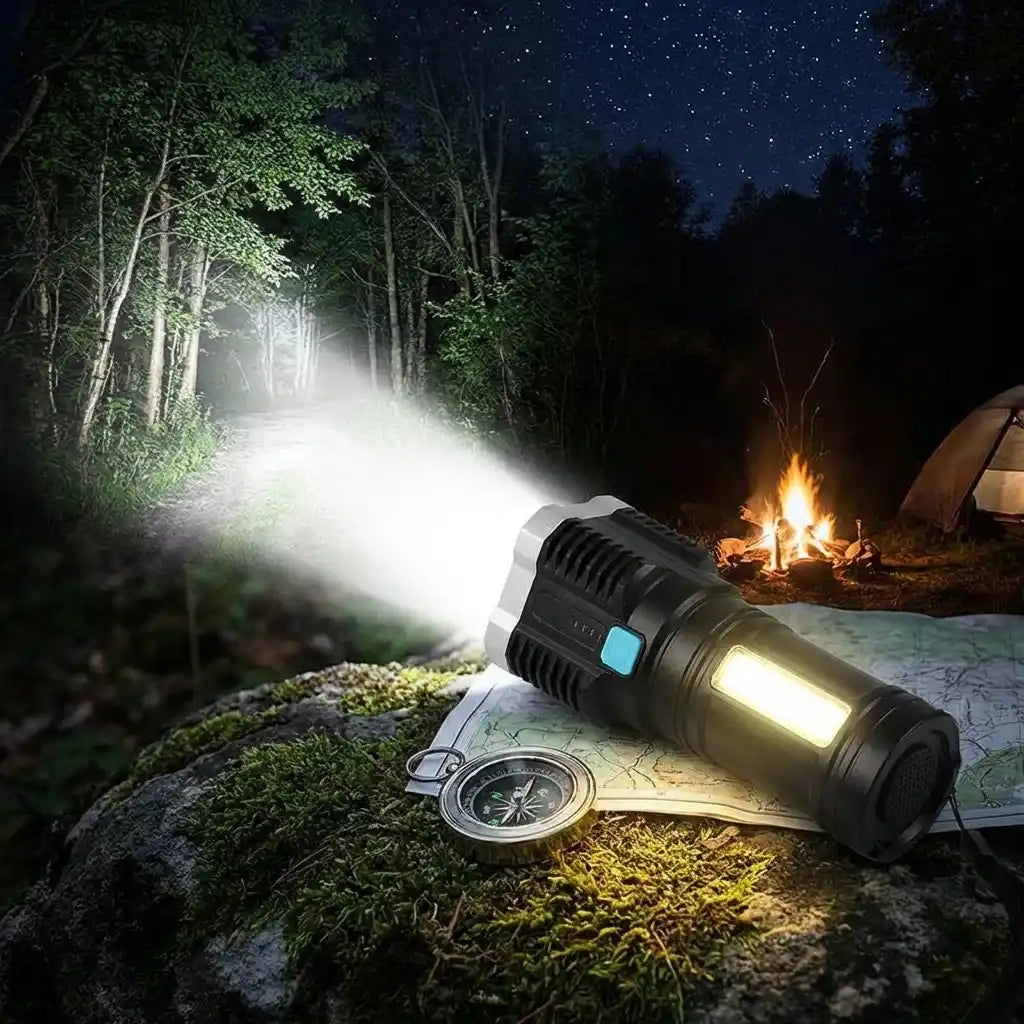 LED torch light resting on ground, front emits bright beam with blue indicator