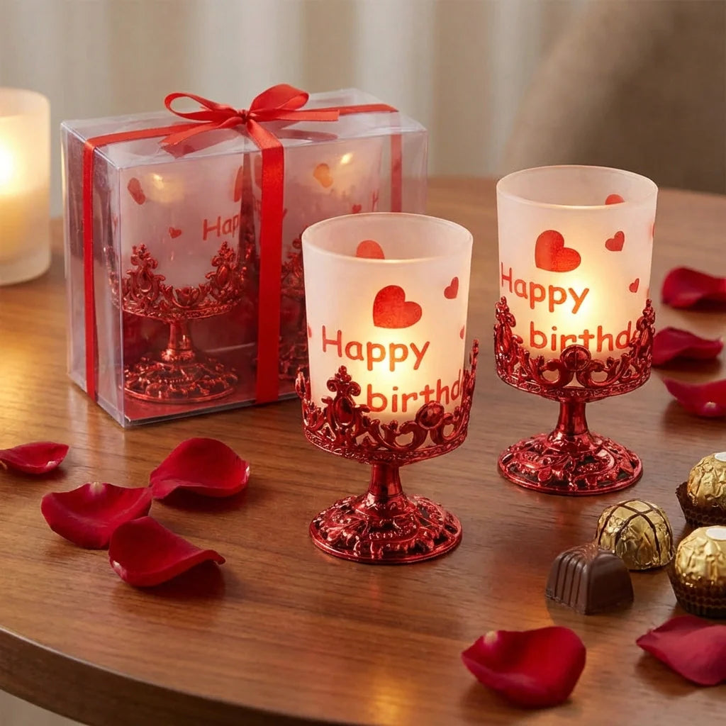 Set of candle stands with frosted candles, red ornate bases, and heart “Happy birth” prints