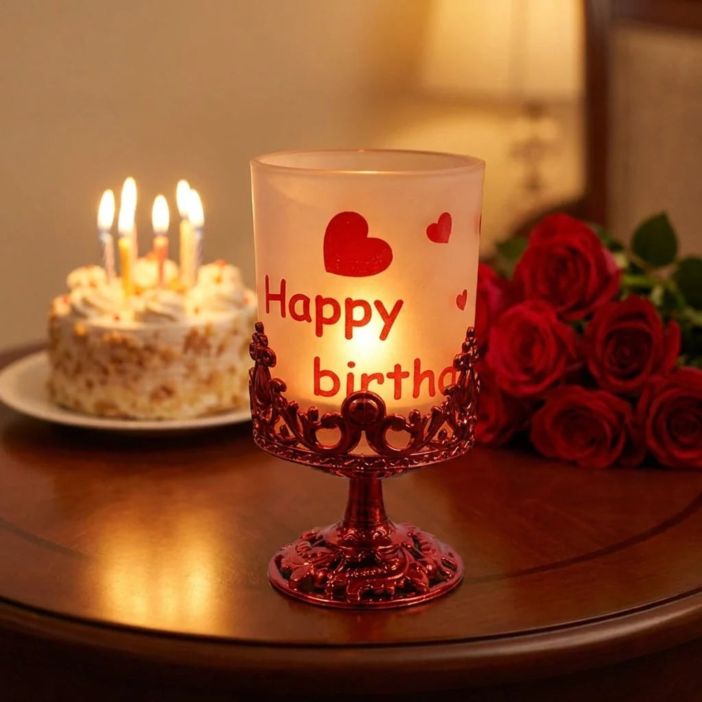 Candle stand with frosted candle, red ornate base, and heart “Happy birth” decal