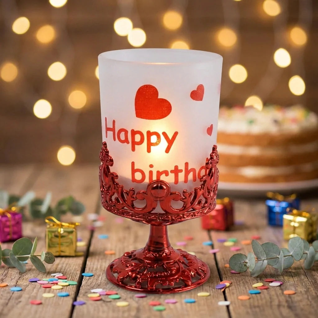 Candle stand with frosted candle, red ornate base, and heart “Happy birth” print