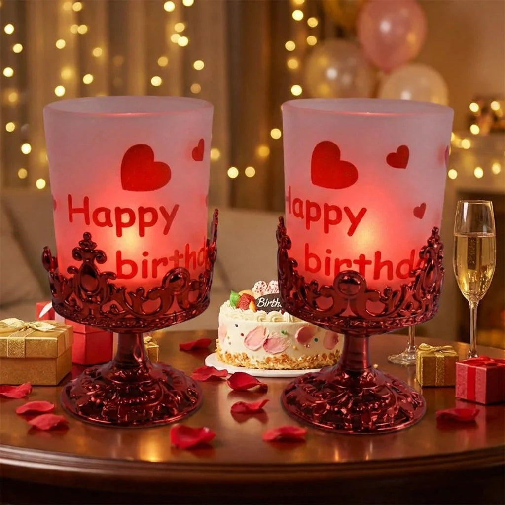 Pair of candle stands with frosted candles, red ornate bases, and heart “Happy birth” print
