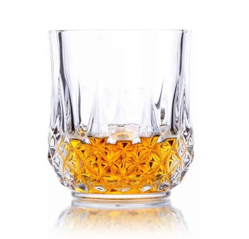Faceted transparent drinking glass with amber tint and diamond cut base
