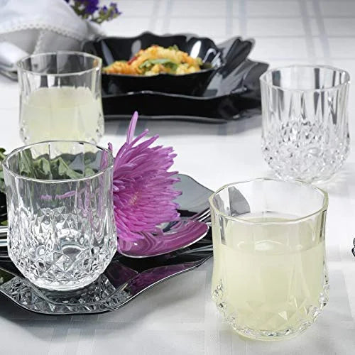 Transparent diamond-cut drinking glasses set with clear and pale yellow tumblers